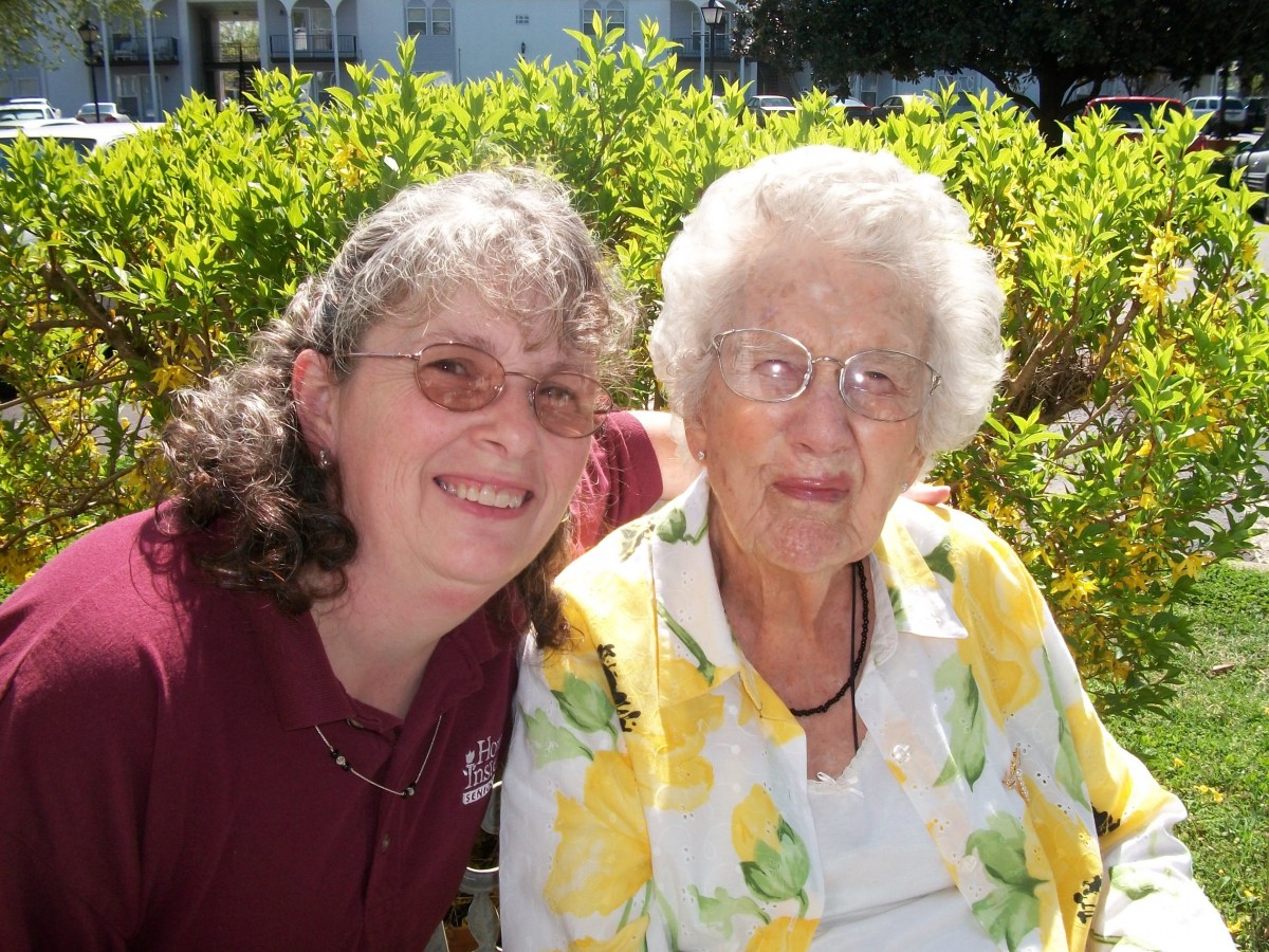 A middle-aged woman and an elderly woman enjoying a sunny day outdoors.