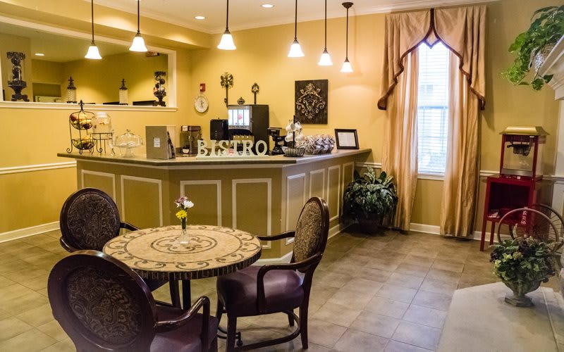 Cozy cafe interior with a decorative table and chairs.