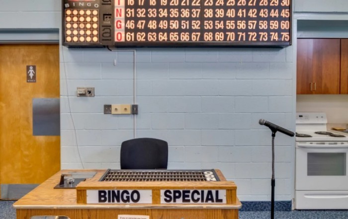 Bingo hall setup with number board and microphone ready for the game.