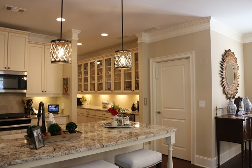 A beautifully designed modern kitchen featuring elegant lighting and a stylish bar counter.