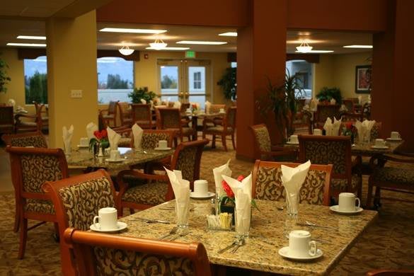 An elegant restaurant dining area with neatly set tables and warm lighting.