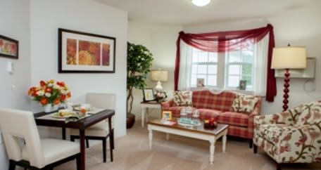 A cozy living room with a plaid couch, coffee table, and decorative elements.