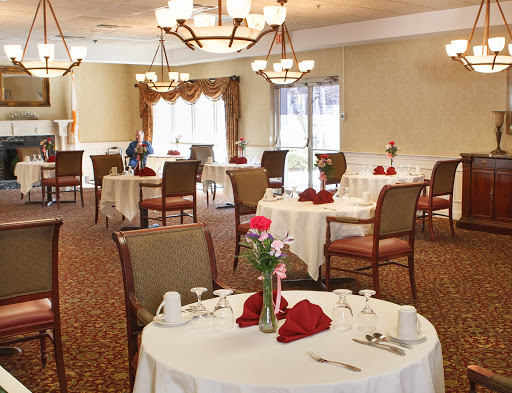 A beautifully arranged dining room ready for guests, featuring elegant decor and table settings.