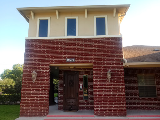 A brick building with large windows and an inviting entrance.