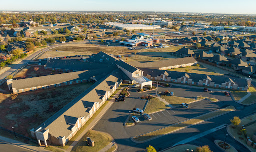 Aerial view of a commercial complex with buildings and a parking lot.