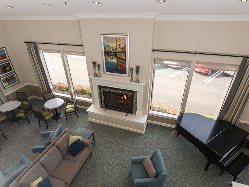 A cozy living room with a fireplace and modern furniture.