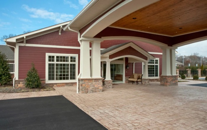 The building features a welcoming entrance with large windows and an awning.