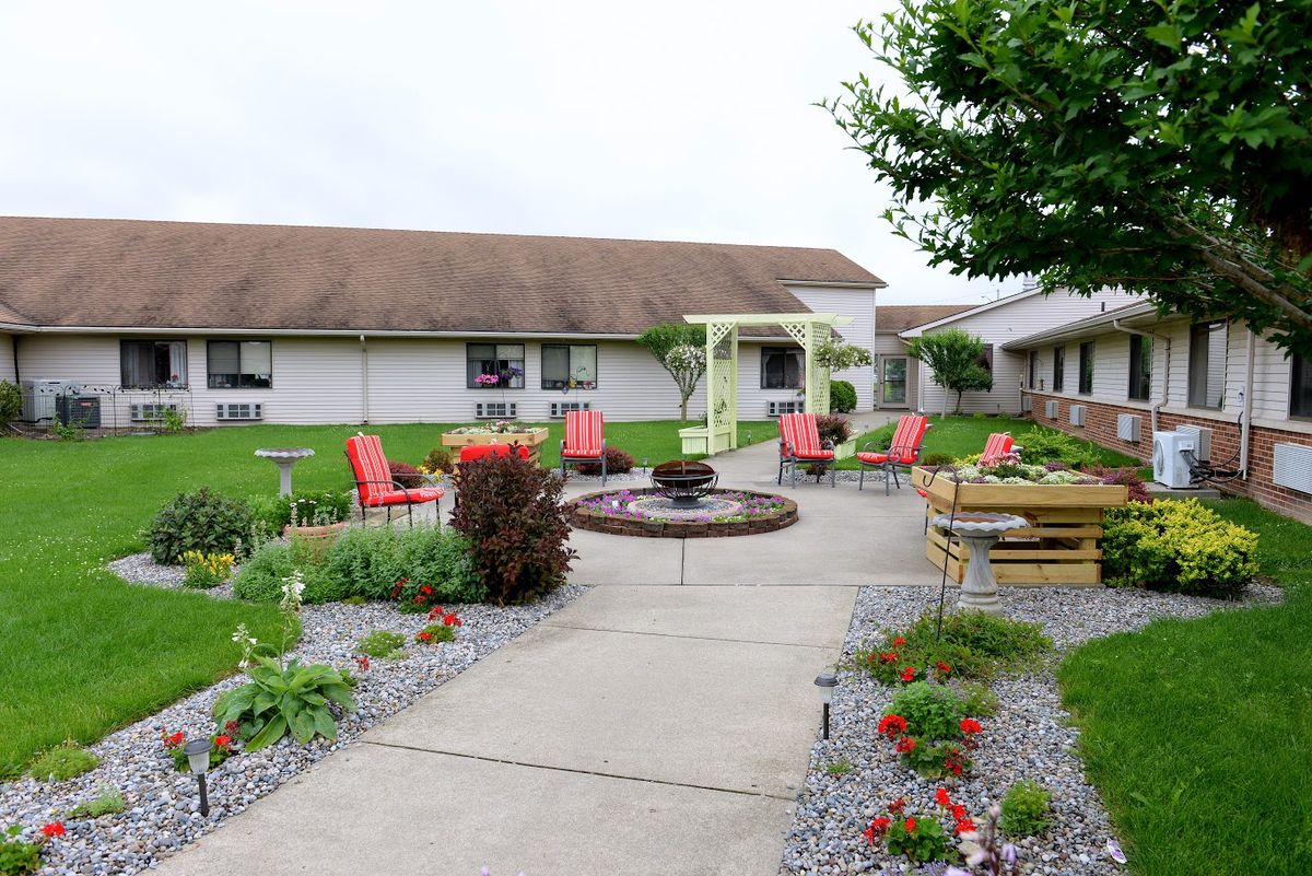 A well-maintained outdoor patio area with seating and landscaped gardens.