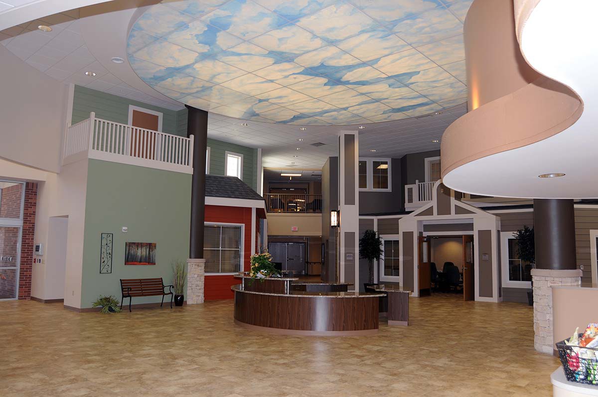 A modern reception area featuring a sky-themed ceiling and contemporary architectural design.