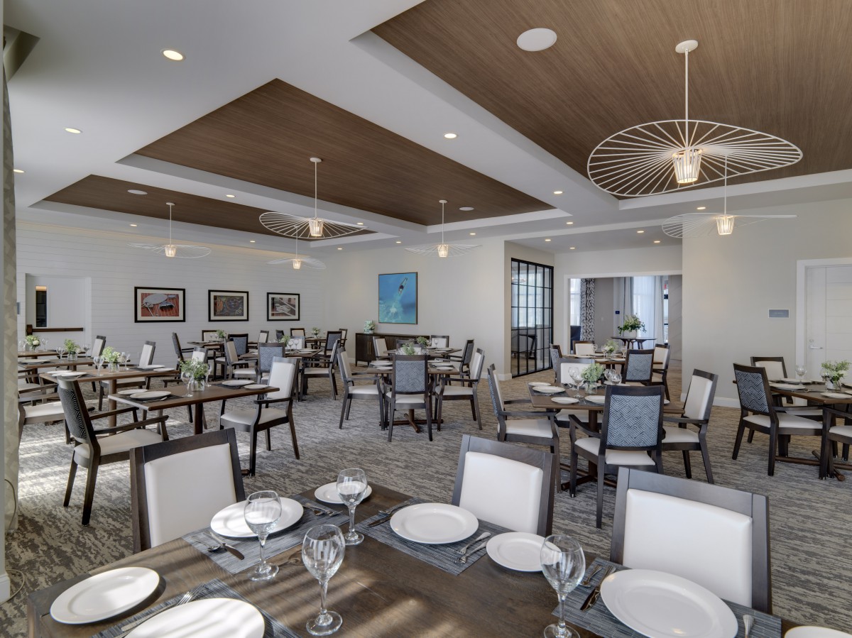 A modern dining room with neatly arranged tables and elegant decor.