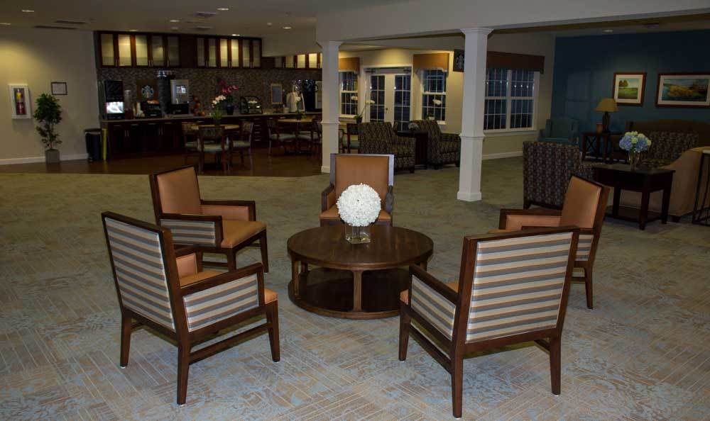 A cozy indoor seating area with four chairs surrounding a central table.