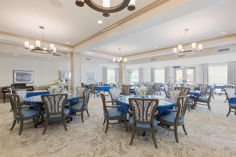 Elegant dining room with round tables and blue accents.
