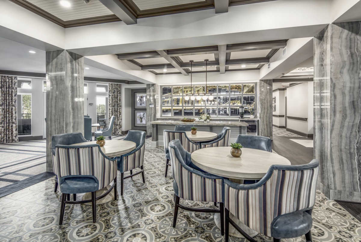 A modern restaurant interior featuring elegant seating and a stylish bar area.