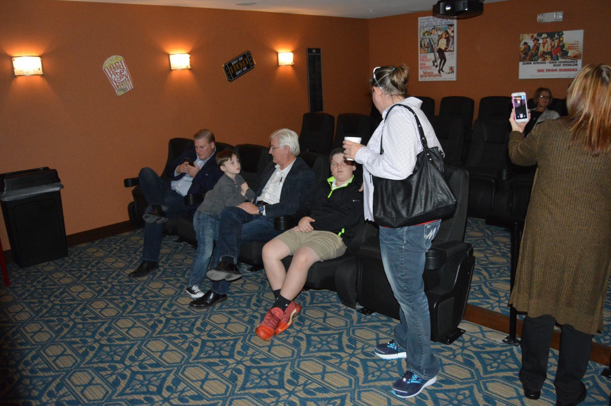 A group of people relaxing in a home theater setting.