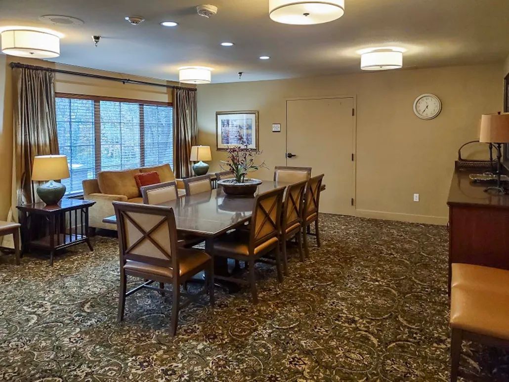 A cozy dining room with a large conference table and elegant decor.