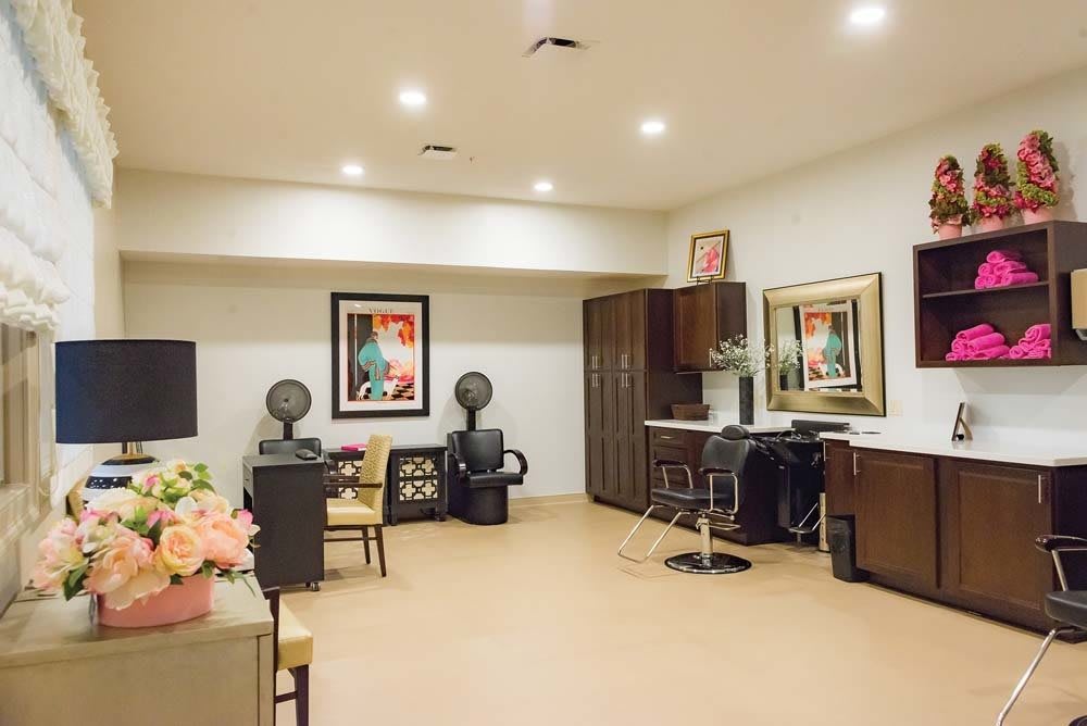 A stylish hair salon with modern decor and seating arrangements.