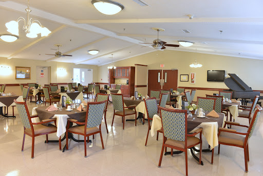 A spacious dining area featuring neatly arranged tables and chairs, creating a welcoming atmosphere.