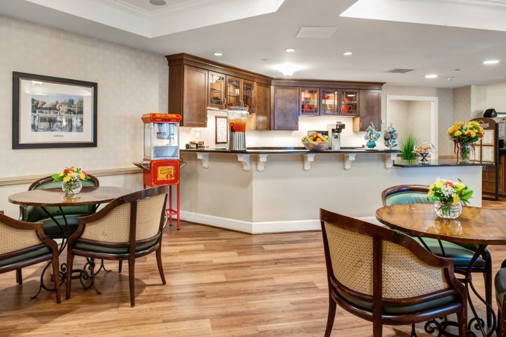 A cozy seating area with a bar counter and popcorn machine.