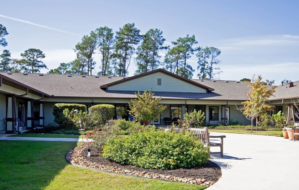 A single-story building with a landscaped garden and pathway.