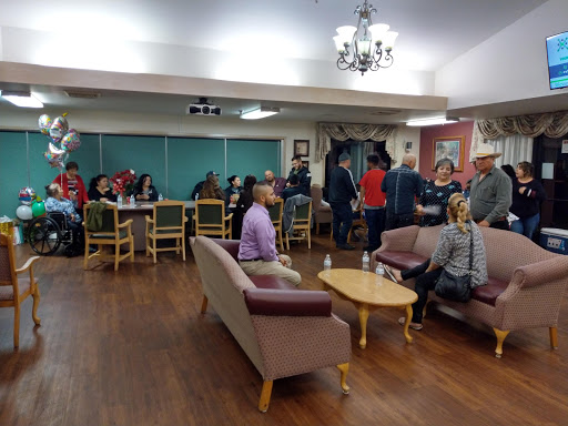 A lively gathering in a community center, with people engaged in conversation and enjoying the space.