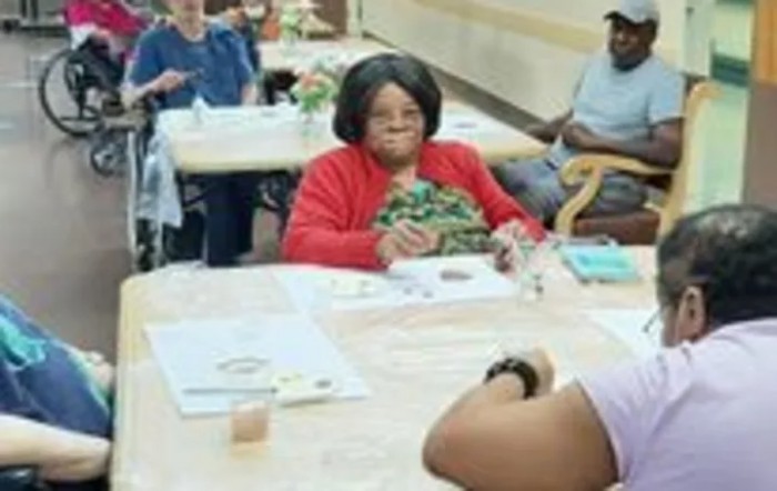 A group of individuals participating in an art activity indoors.