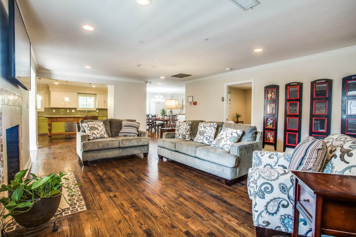 A spacious and elegantly designed living room with wood flooring and modern furniture.