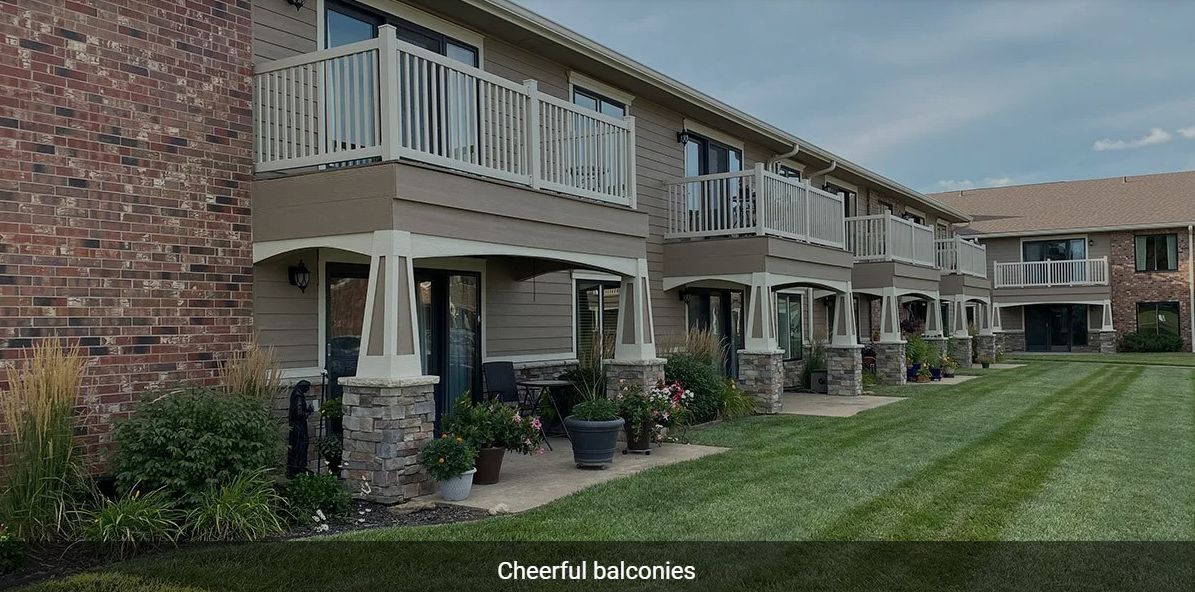 Modern apartment building with well-maintained balconies and gardens.