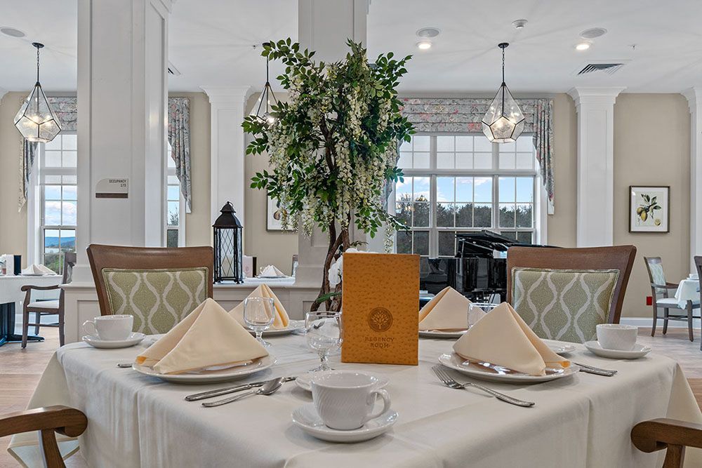 An elegantly set dining table with folded napkins and a menu in an upscale restaurant.