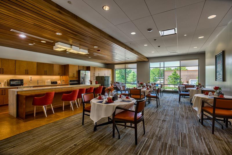 A modern dining area with stylish furniture and ample natural light.
