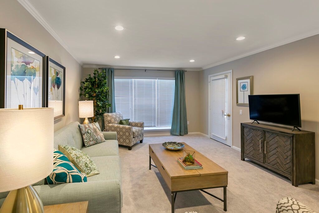 A cozy and well-designed living room featuring a comfortable sofa, patterned armchair, and modern decor.