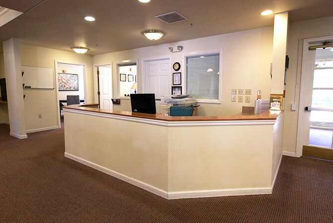 A reception area with a front desk in an office setting.