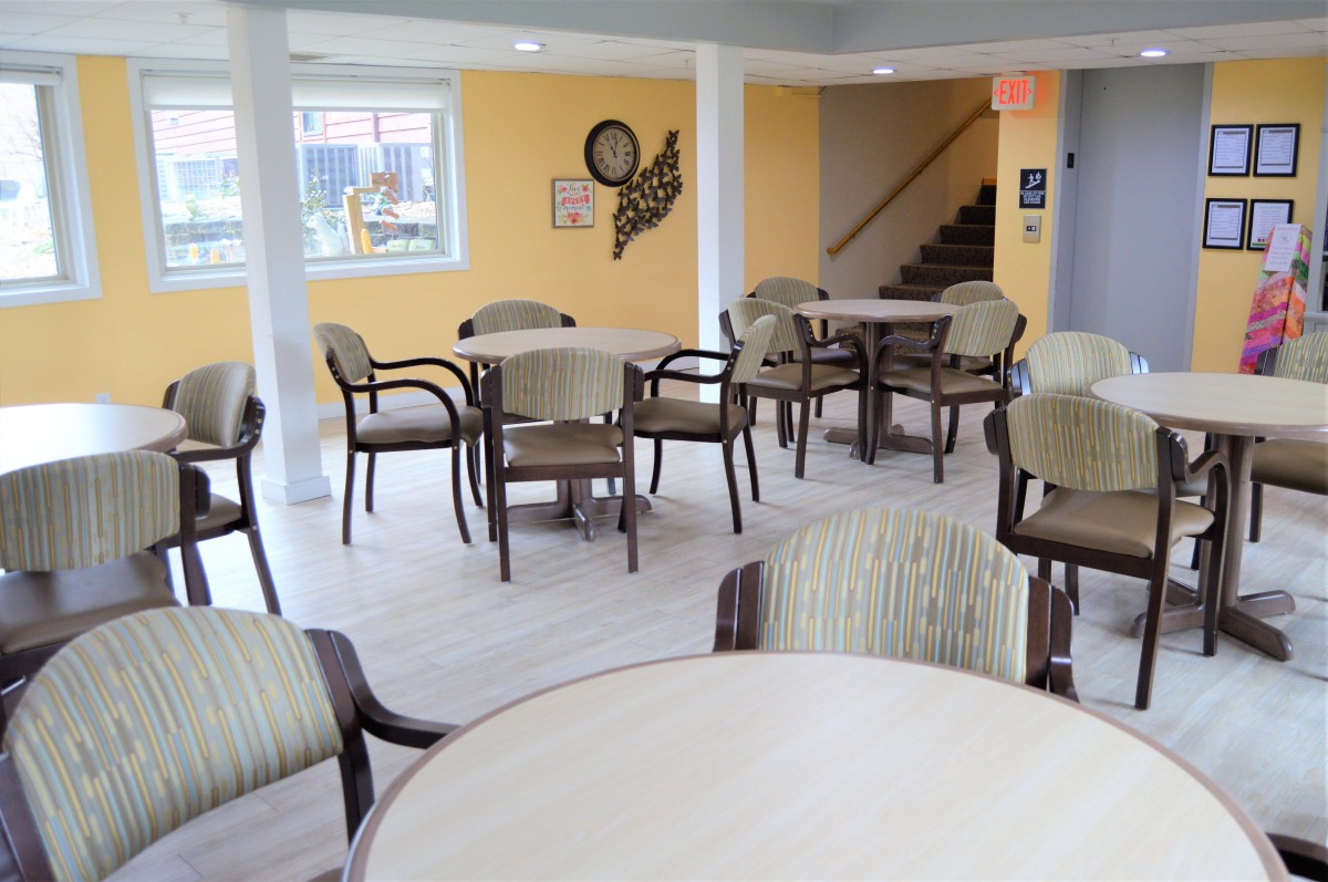 A bright and modern seating area with tables and chairs.