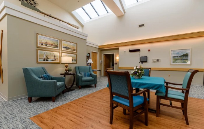A cozy lounge area with comfortable seating and natural lighting from a skylight.