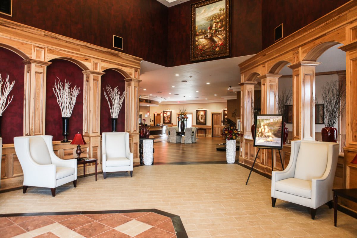 A spacious hotel lobby with elegant furniture and warm decor.