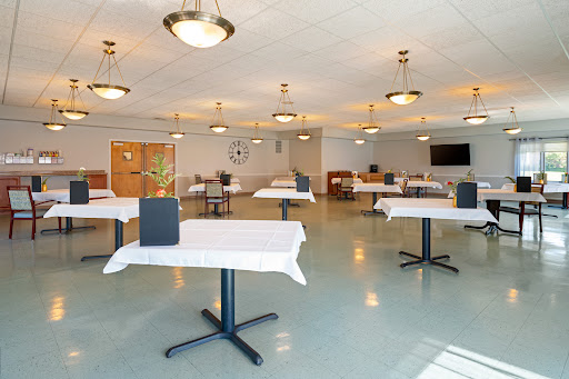 A spacious dining area with neatly arranged tables, ready for guests.