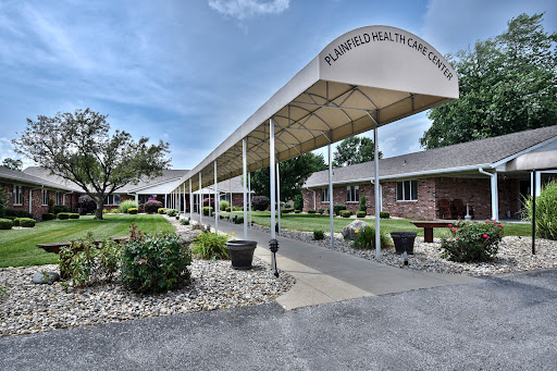 A well-maintained building with a walkway and landscaped garden under a clear blue sky.