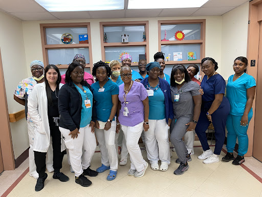 A dedicated team of healthcare professionals posing together in a hospital setting.