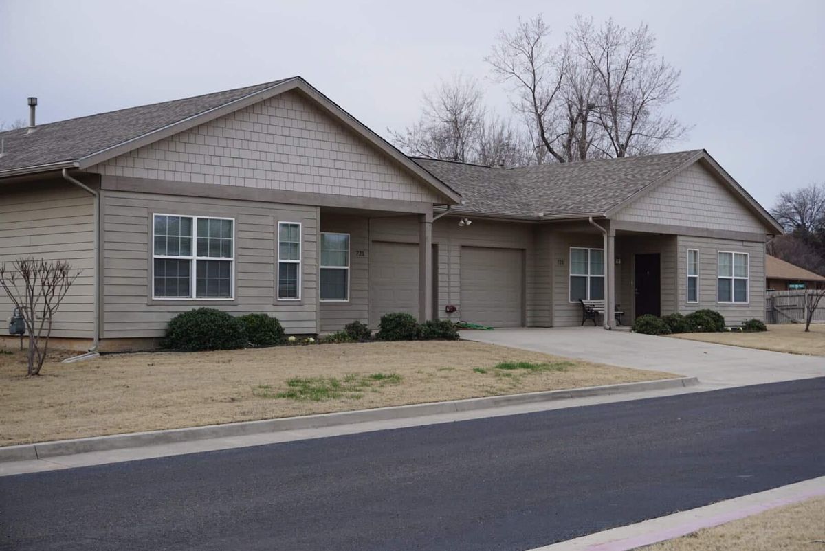 A suburban residential house with a driveway and garage.