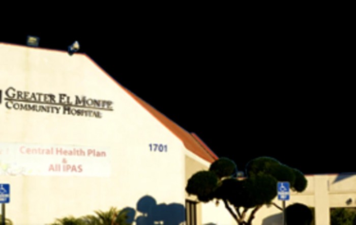 A building with a sign illuminated at night.
