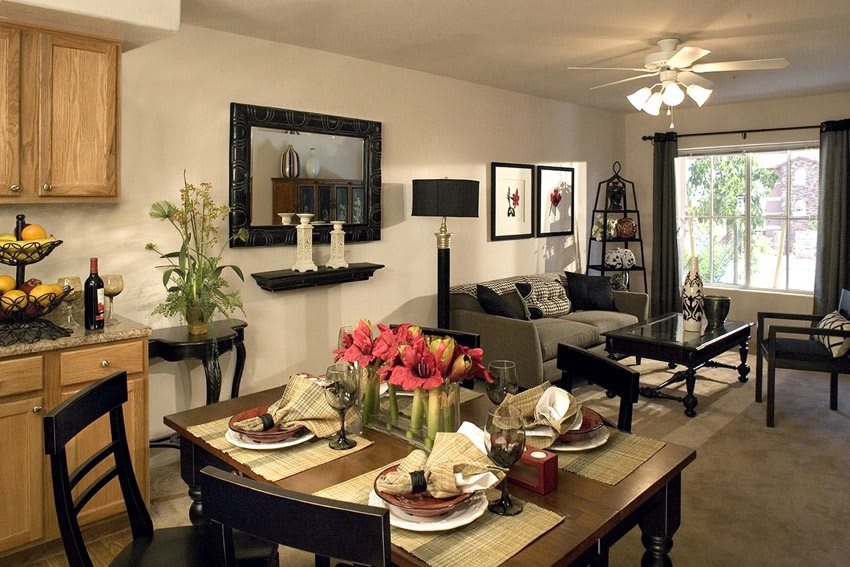 A modern living and dining area featuring stylish furniture and elegant table settings.