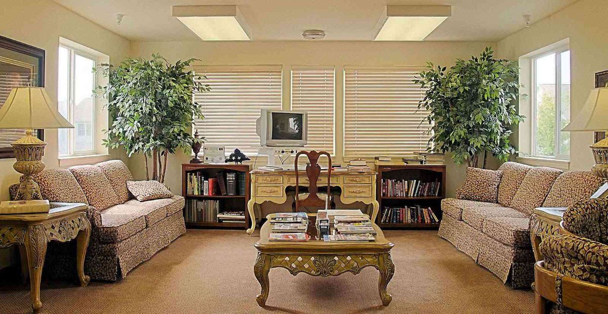 A vintage-themed office with a classic desk, old computer, and cozy seating area.