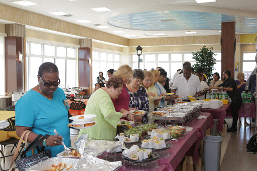 Guests enjoying a diverse buffet at a lively gathering.