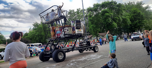 A vibrant parade float featuring colorful decorations and entertainers, bringing joy to the crowd.