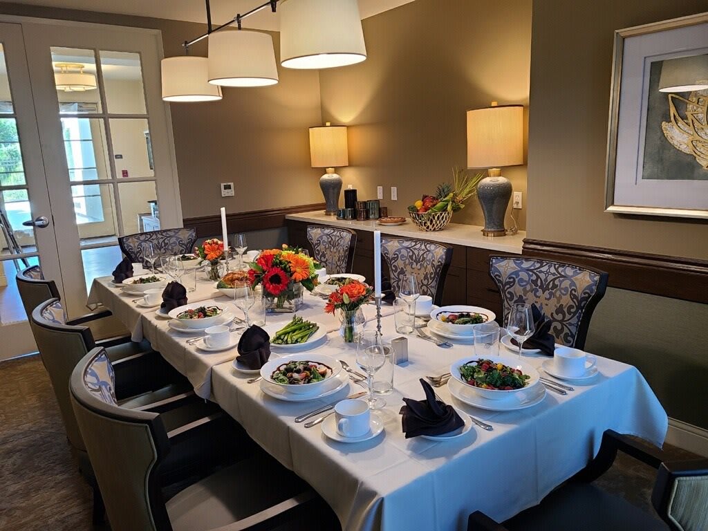 A beautifully set dining table prepared for a formal dinner with elegant decor and candles.
