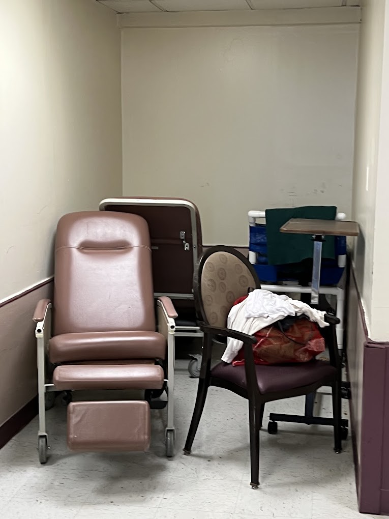 A small corner with several chairs and a recliner, possibly in a hospital waiting area.