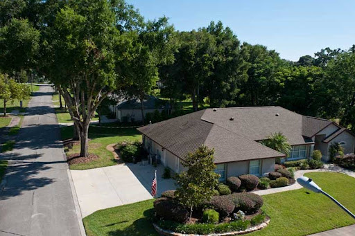 A picturesque view of a well-maintained residential home surrounded by lush greenery.
