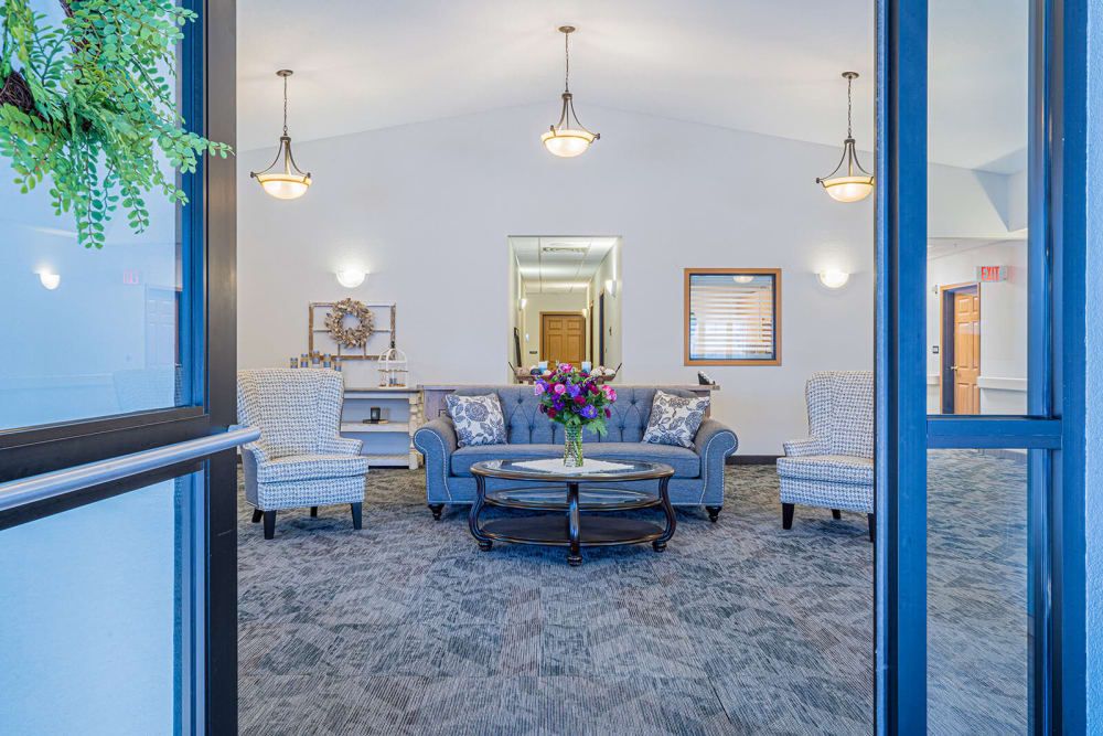 A cozy and well-lit living room with comfortable seating and elegant decor.