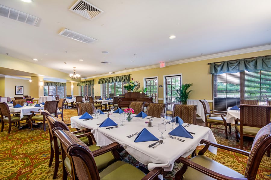 Elegant dining area with neatly set tables and chairs.