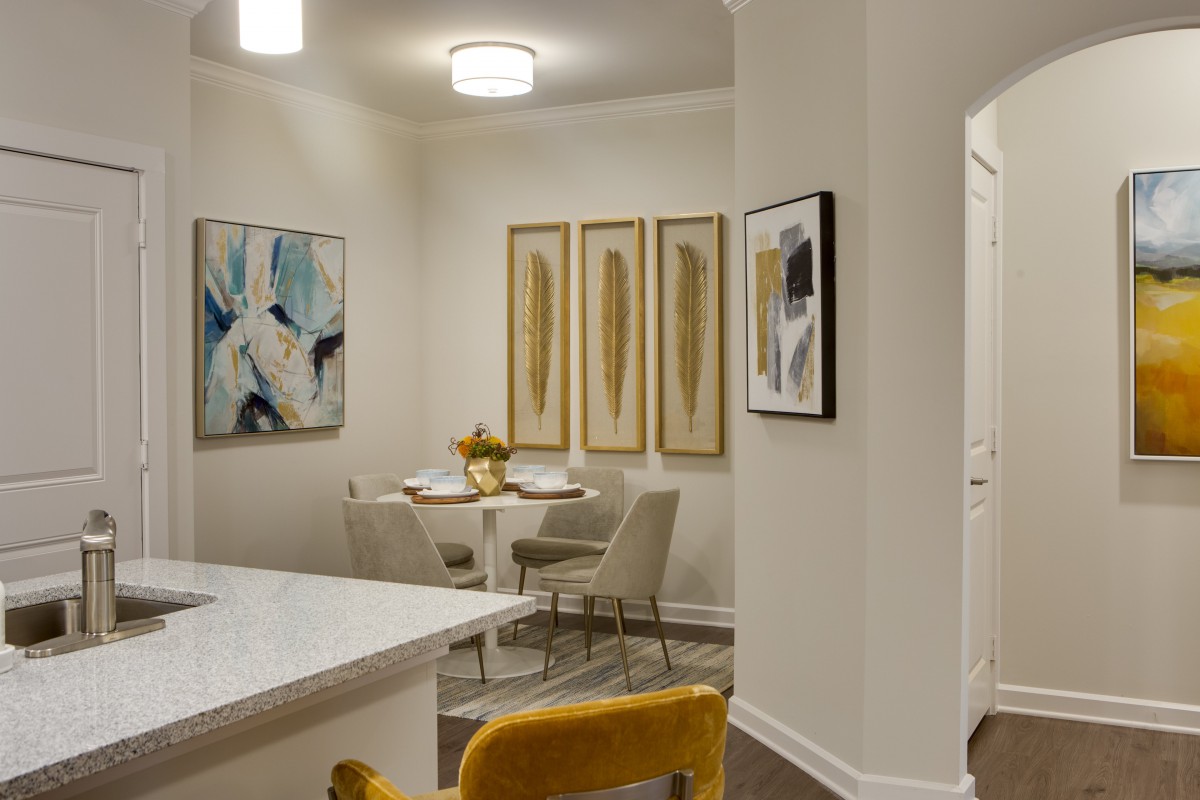 A modern dining area with elegant artwork and contemporary furnishings.