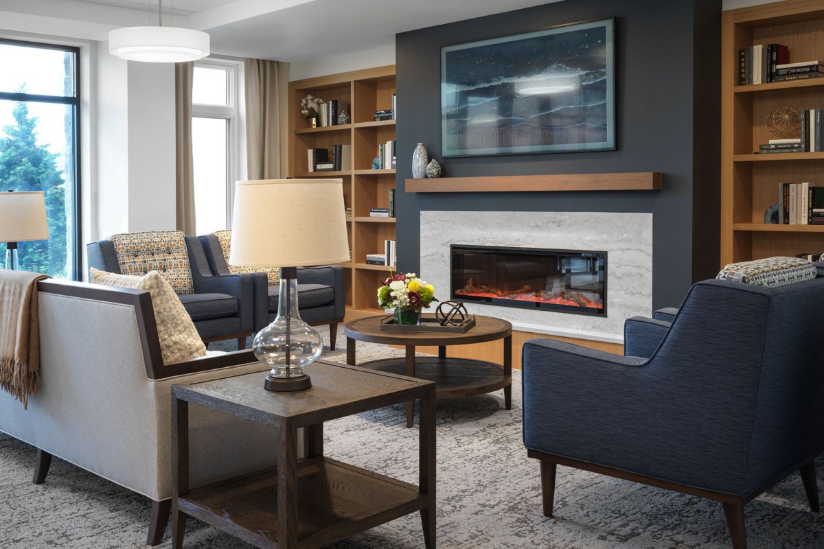 A modern living room with a cozy fireplace and elegant furniture.